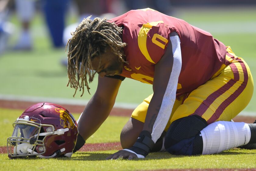 USC Trojans defensive lineman Korey Foreman kneels in the end zone before playing the San Jose State.