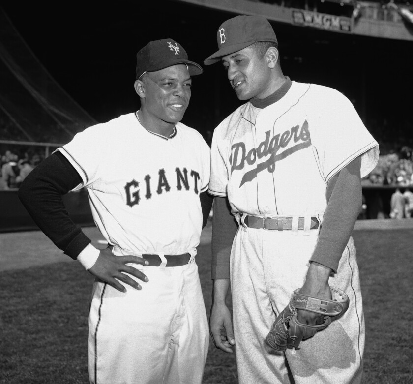Don Newcombe, right, talks with Willie Mays in 1954.