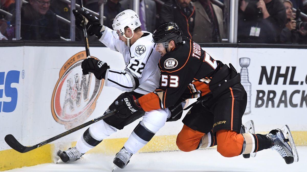 Kings' Trevor Lewis (22) and Ducks' Shea Theodore (53) battle for the loose puck in the corner in the second period at the Honda Center Sunday.