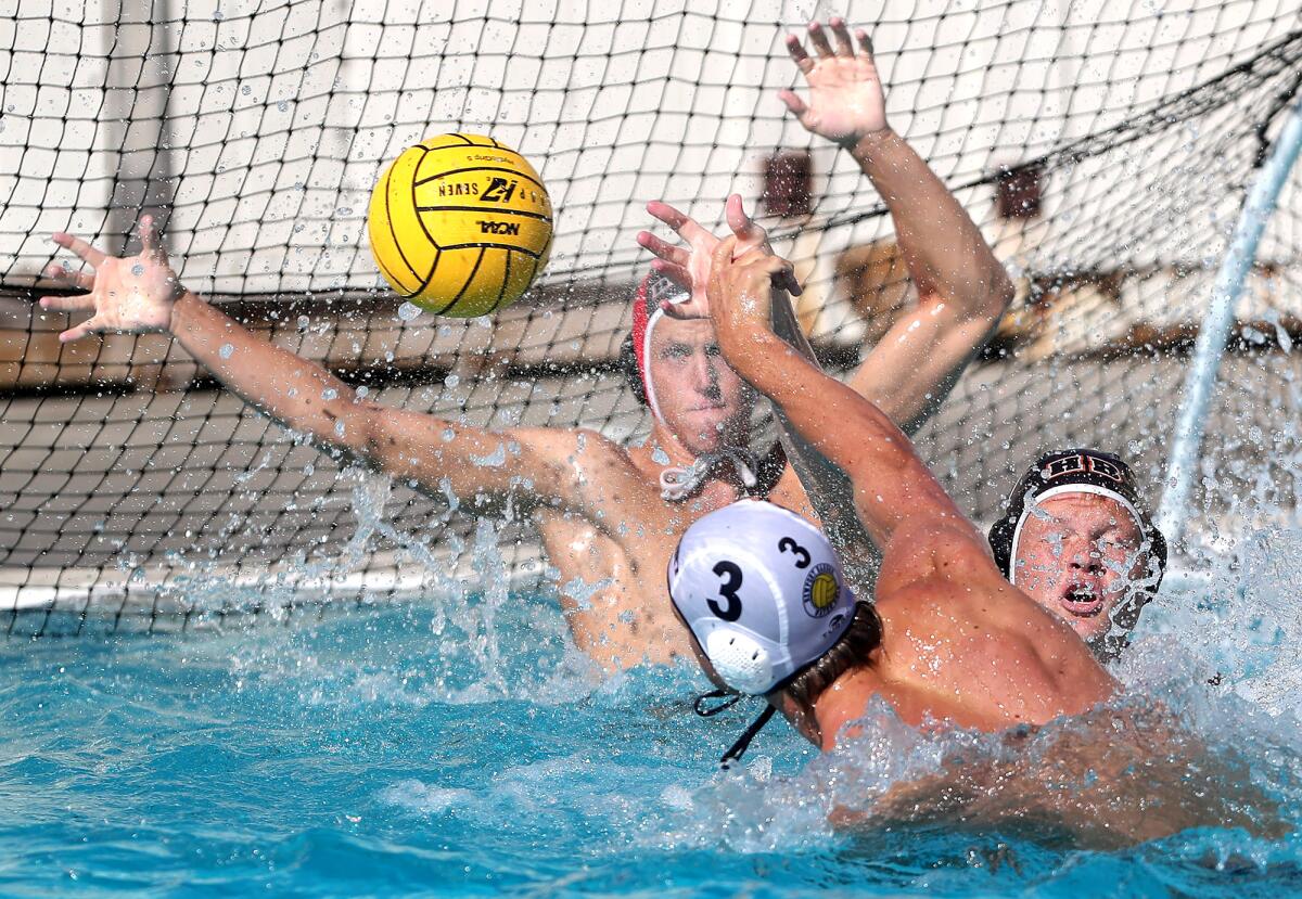 Newport Harbor's Trey Smith (3) shoots and scores into the corner of the net against Huntington Beach on Wednesday.