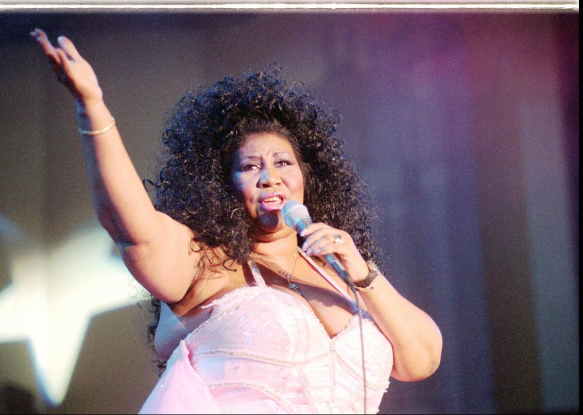 Aretha Franklin sings during a kick-off concert for the Democratic National Convention on Aug. 23, 1996, in Chicago's Grant Park.