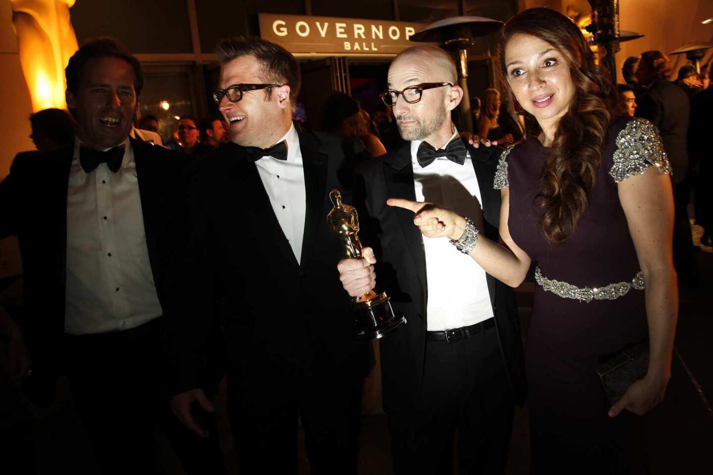 "Bridesmaids" actress Maya Rudolph jokes with Jim Rash, who holds his Oscar for best adapted screenplay for "The Descendants."