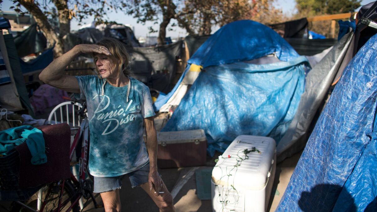 Kathy Schuler has been living in a large encampment next to the Santa Ana River for about three years. An estimated 4,800 people are homeless in Orange County, and shelter space hasn t kept up with demand.