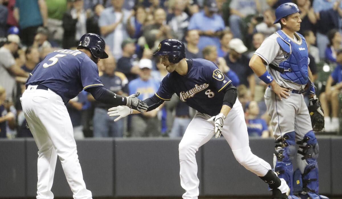 Milwaukee Brewers' Ryan Braun, right, celebrates his two-run homerun with Jonathan Villar during the seventh inning against the Dodgers on Wednesday.