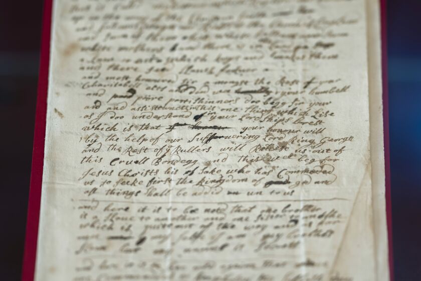 The handwritten letter from 1723 – whose author says they are remaining anonymous for fear they will "swing upon the gallows tree" if exposed, is displayed at the exhibition in the Lambeth Palace Library, in London, Tuesday, Jan. 31, 2023. A letter written by an enslaved person in Virginia 300 years ago seeking freedom is part of a new exhibition exploring the Church of England's historic links to slavery. It's part of efforts by the Anglican church to reckon with its historic complicity in slavery. (AP Photo/Kin Cheung)