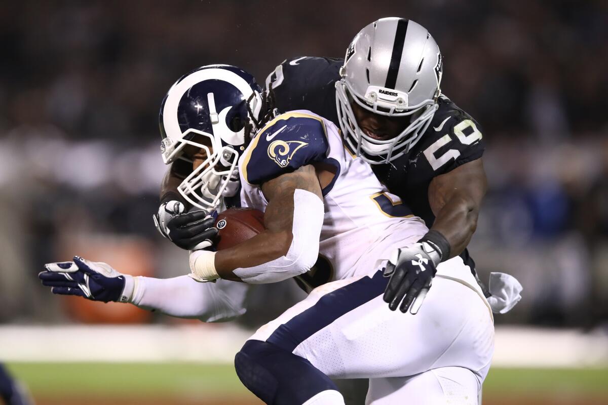 Los Angeles Rams Todd Gurley is tackled by Oakland Raiders linebacker Tahir Whitehead.