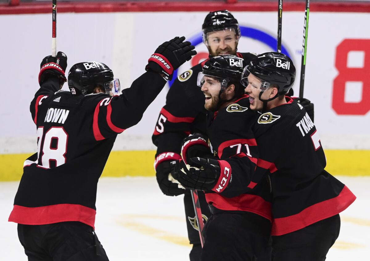 Ottawa Senators center Chris Tierney (71) celebrates a goal against the Toronto Maple Leafs with teammates during the second period of an NHL hockey game Friday, Jan. 15, 2021, in Ottawa, Ontario. (Sean Kilpatrick/The Canadian Press via AP)