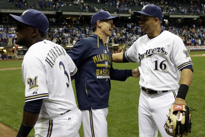 Brewers Manager Craig Counsell celebrates with Elian Herrera (3) and Aramis Ramirez (16) after winning his first game. The Brewers beat the Dodgers, 4-3.