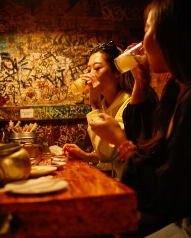 Two women enjoy drinks at Dan Sung Sa in Koreatown.
