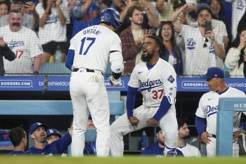 Los Angeles Dodgers designated hitter Shohei Ohtani, left, celebrates his go-ahead two-run home run with Teoscar Hernandez during the seventh inning of a baseball game against the Arizona Diamondbacks, Tuesday, July 2, 2024, in Los Angeles. (AP Photo/Ryan Sun)