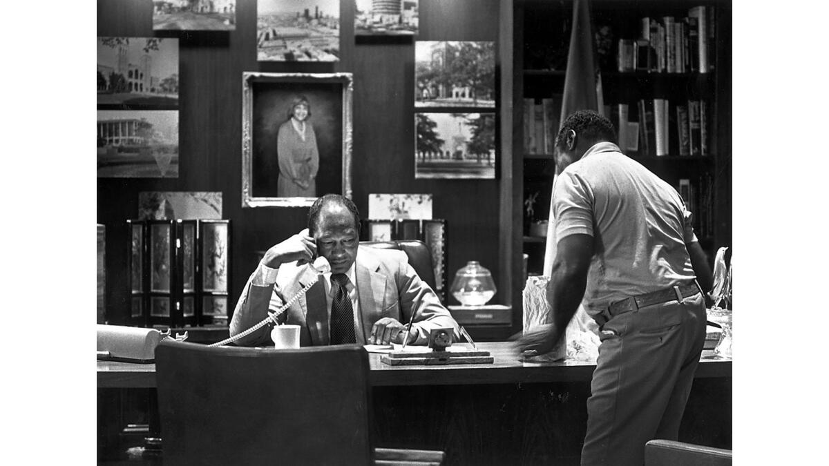 Sept. 18, 1990: During his monthly open house, Los Angeles Mayor Tom Bradley takes a phone call in his office as a visiting citizen, William Gentry, waits.