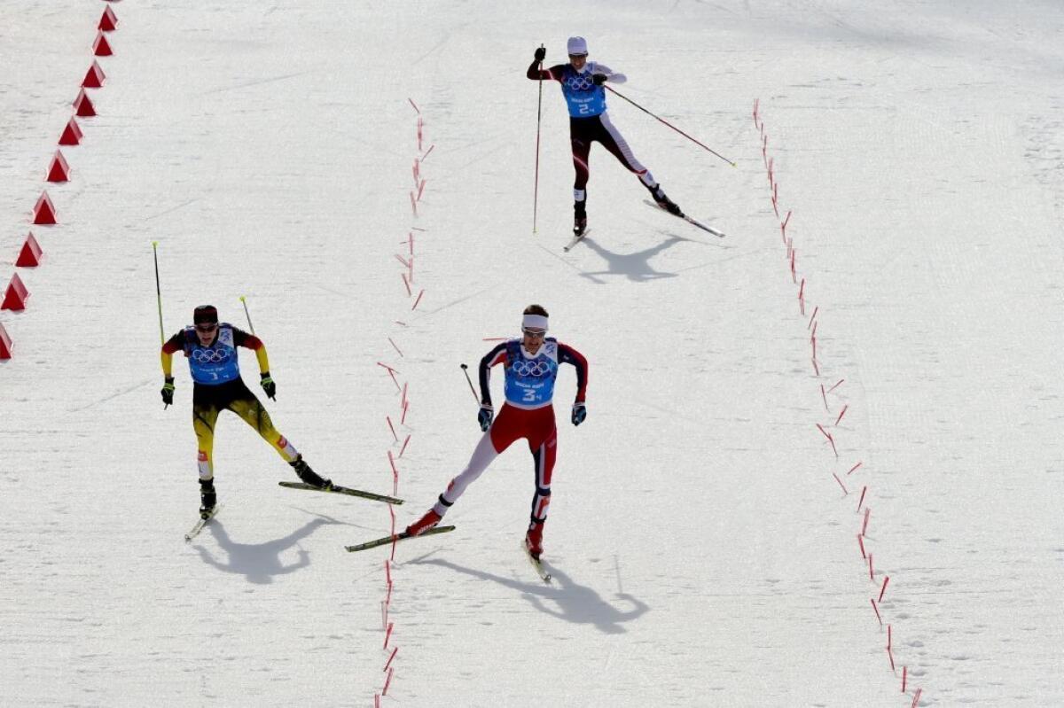 Germany's Fabian Riessle, left, can't quite catch Norway's Joergen Graabak at the finish line. Austria's Mario Stecher trails them both.