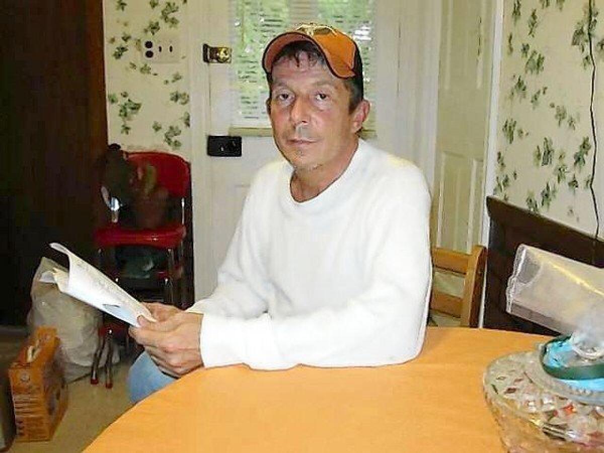 Carl Maxwell Jr., at the kitchen table in his mother's home in Newport, Pa., reviewing the Boy Scouts of America's confidential file detailing the alleged abuse he and four other members of Troop 222 were subjected to by Scoutmaster Rodger L. Beatty in 1976.