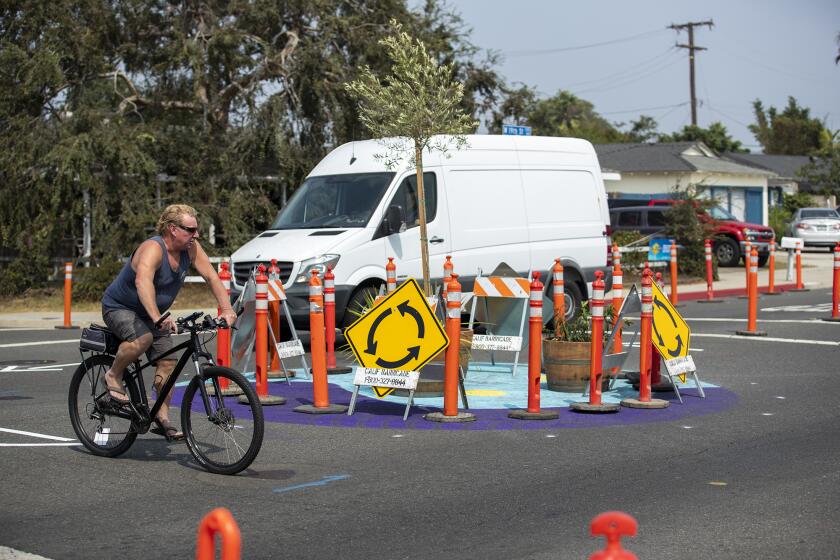 A bicyclist rides through an intersection at 19th St. and Monrovia Ave. in Costa Mesa on Monday, September 14. The Costa Mesa Alliance for Better Streets along with the city of Costa Mesa, installed two temporary traffic circles, or roundabouts on the West side.