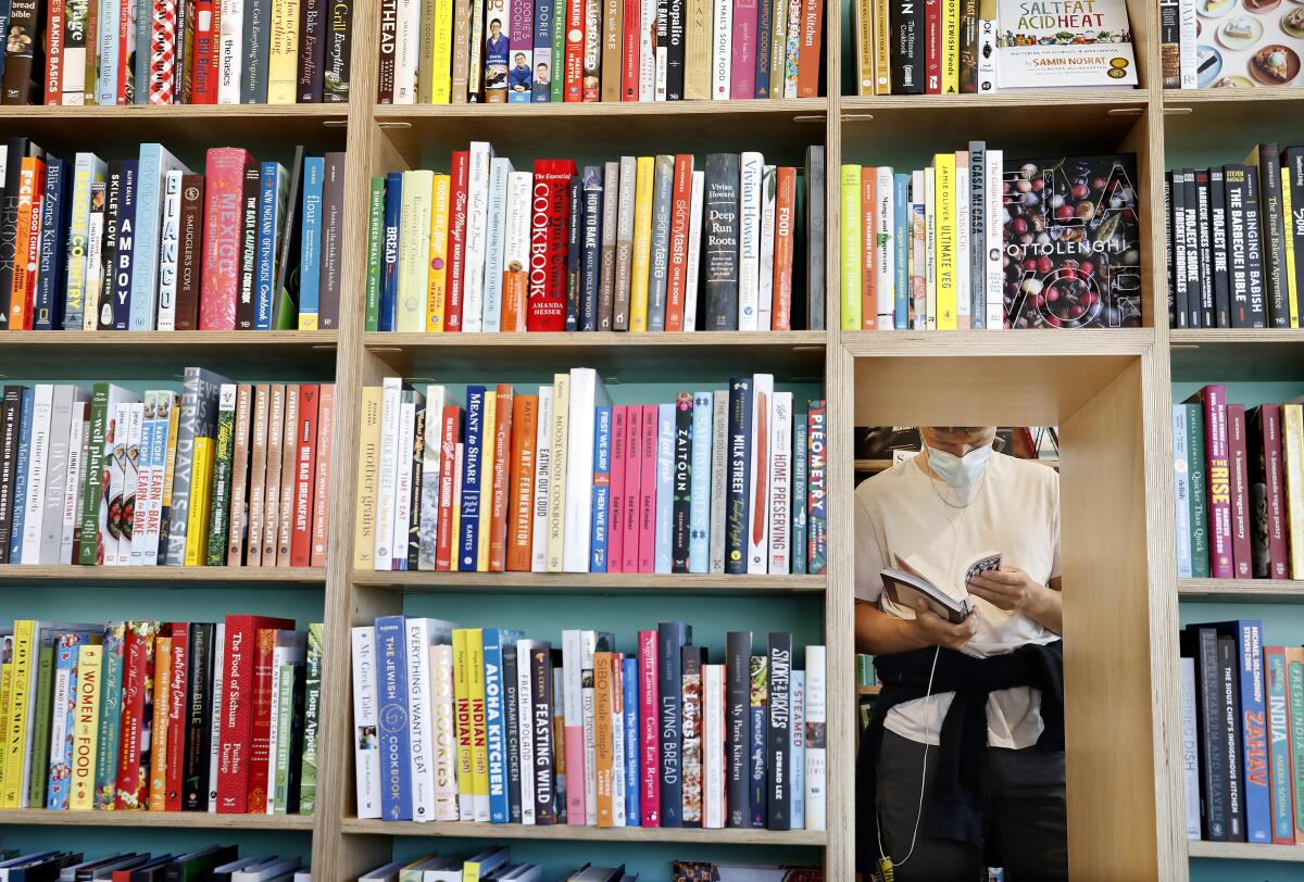 Bookshelves frame a body.