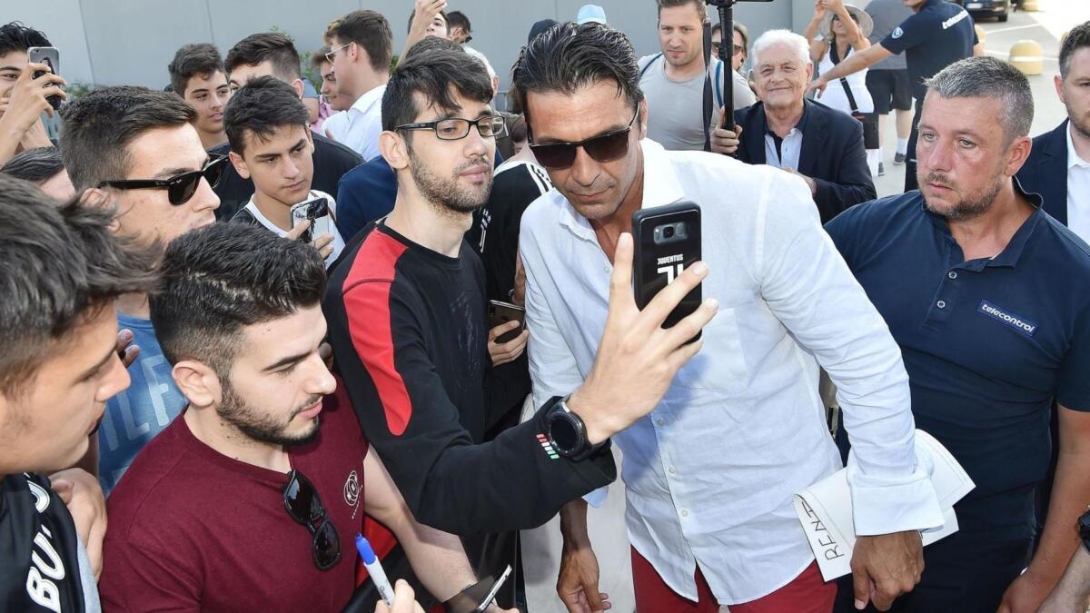 Italian goalkeeper Gianluigi Buffon meets the crowds as he arrives for medical examinations at Juventus Medical Center in Turin, Italy,