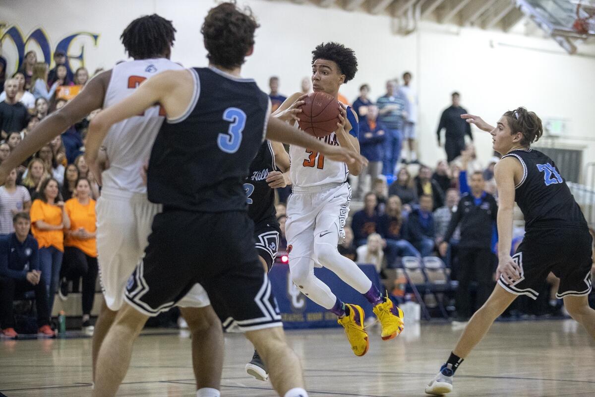 Pacifica Christian Orange County High's Houston Mallette (31), pictured driving into the lane against Dana Hills on Feb. 14, helped the Tritons beat Bakersfield Christian 69-68 in overtime of a CIF State Southern California Regional Division III opener Tuesday.