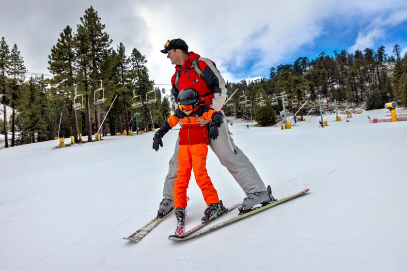 WRIGHTWOOD, CA - DECEMBER 22: Nathan Sheffield, 40, brings out his 7-year-old nephew Cole Kaplan for skiing at Mountain High on Friday, Dec. 22, 2023 in Wrightwood, CA. (Irfan Khan / Los Angeles Times)