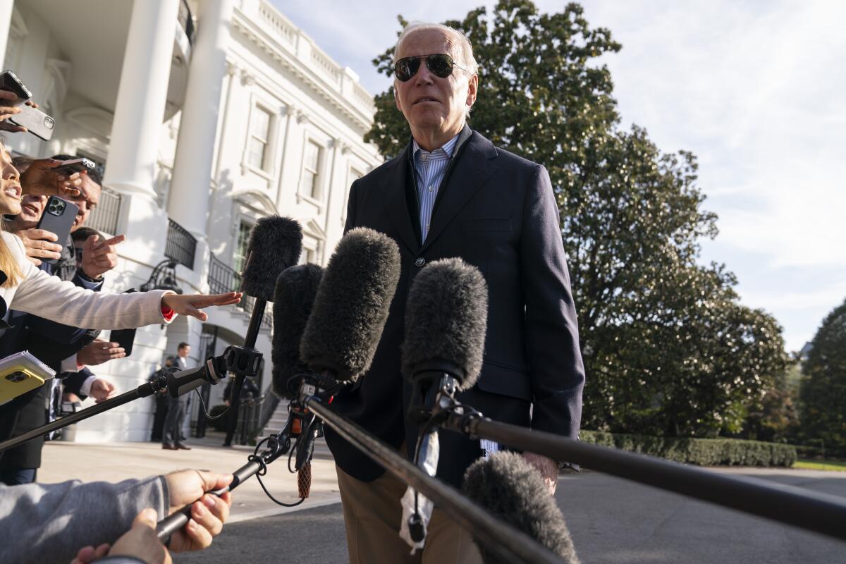 President Joe Biden talks to reporters before boarding Marine One on the South Lawn of the White House, Wednesday, Oct. 12, 2022, in Washington. More U.S. adults are now feeling financially vulnerable amid high inflation. That's a political risk for Biden and his fellow Democrats one month before the midterm elections. (AP Photo/Evan Vucci)