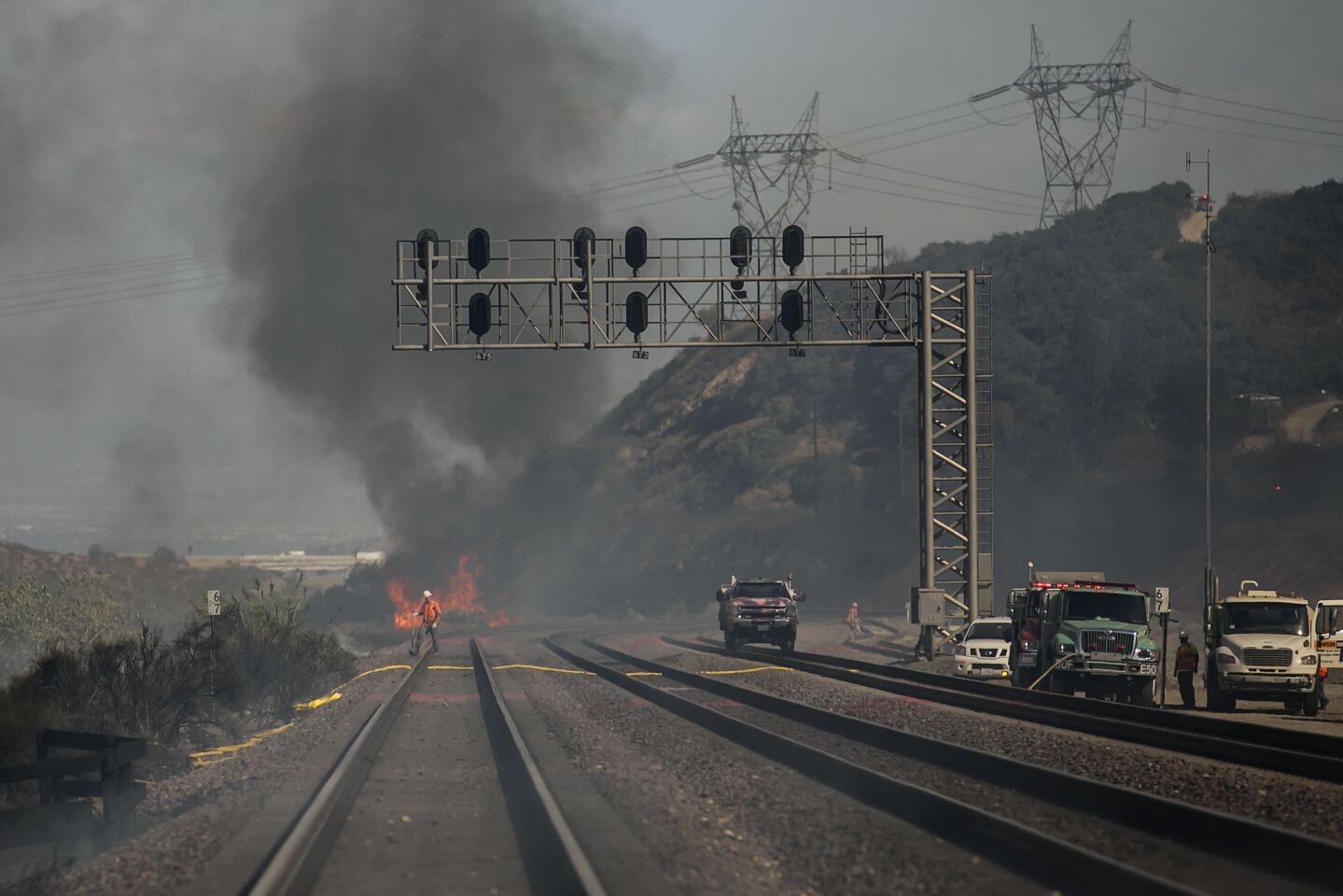 Fire burns on the train tracks near Interstate 15 at Keenbrook in San Bernardino County.