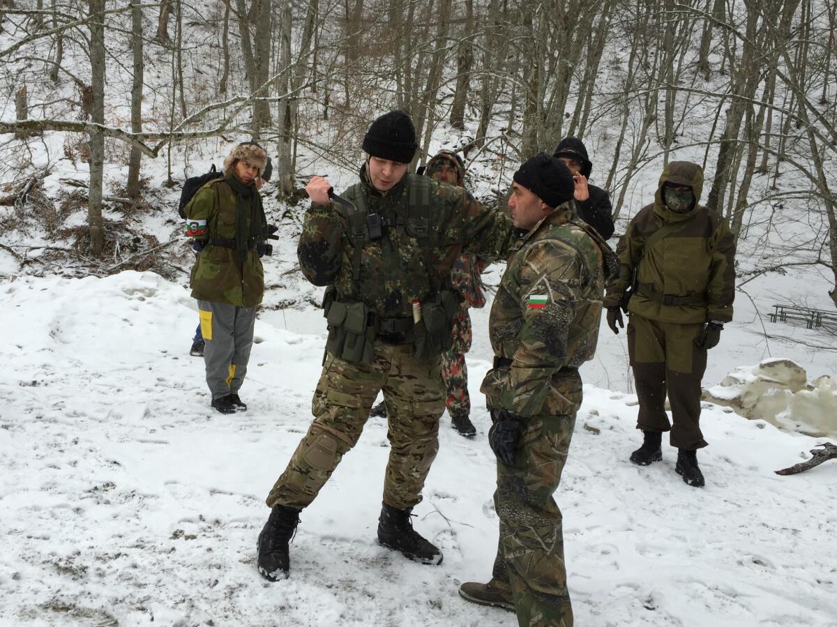 An instructor demonstrates use of a hunting knife to volunteers who aim to stop migrants from crossing into Bulgaria from Turkey.