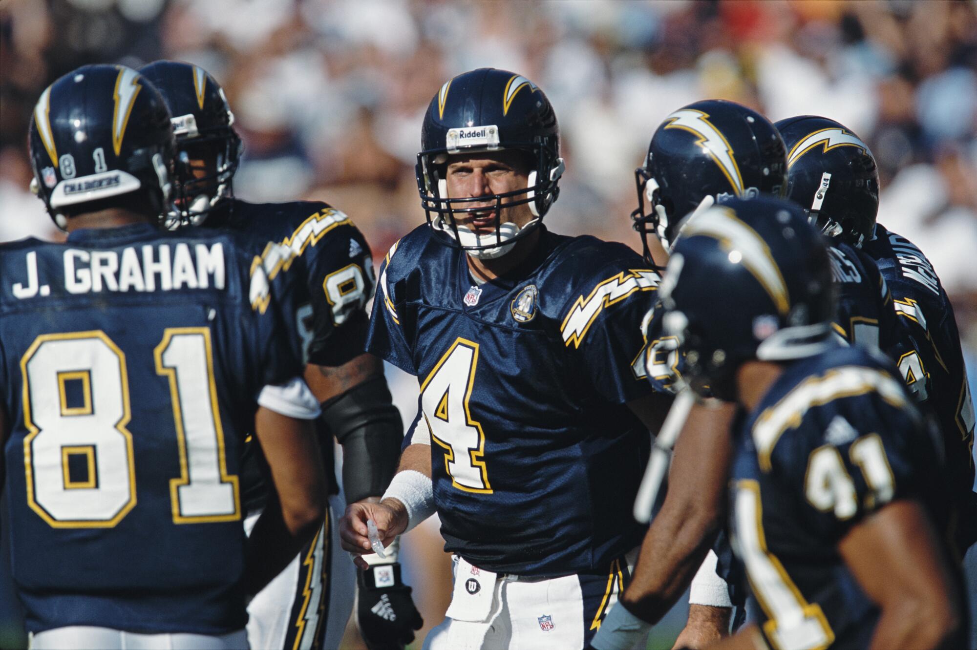 San Diego Chargers quarterback Jim Harbaugh (4)  talks to his offensive line in 2000.