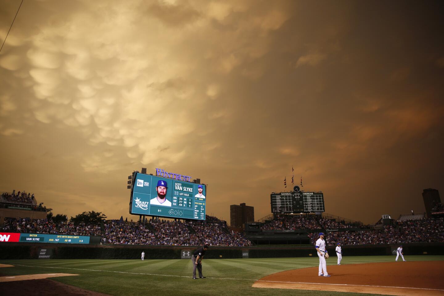Storm clouds begin to roll in as the sun set during the game.