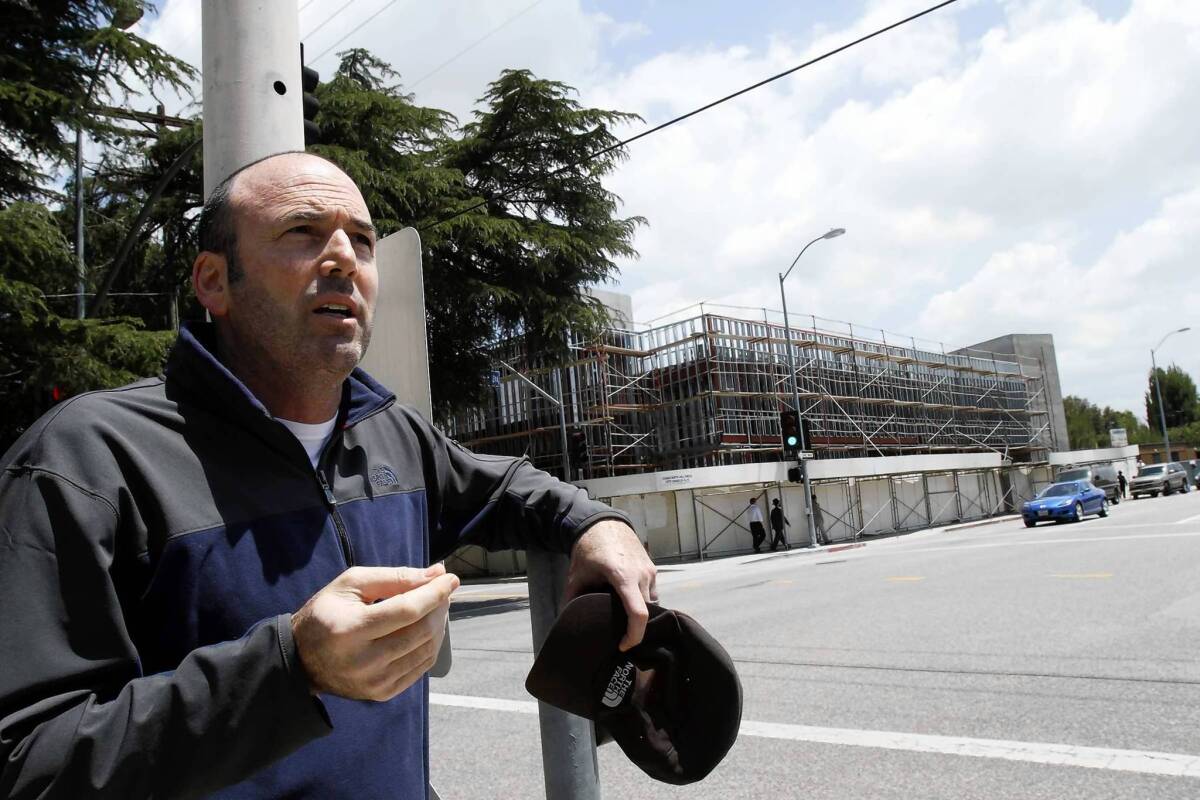 Jeff Gantman stands across from a synagogue in Sherman Oaks that is undergoing a controversial expansion.