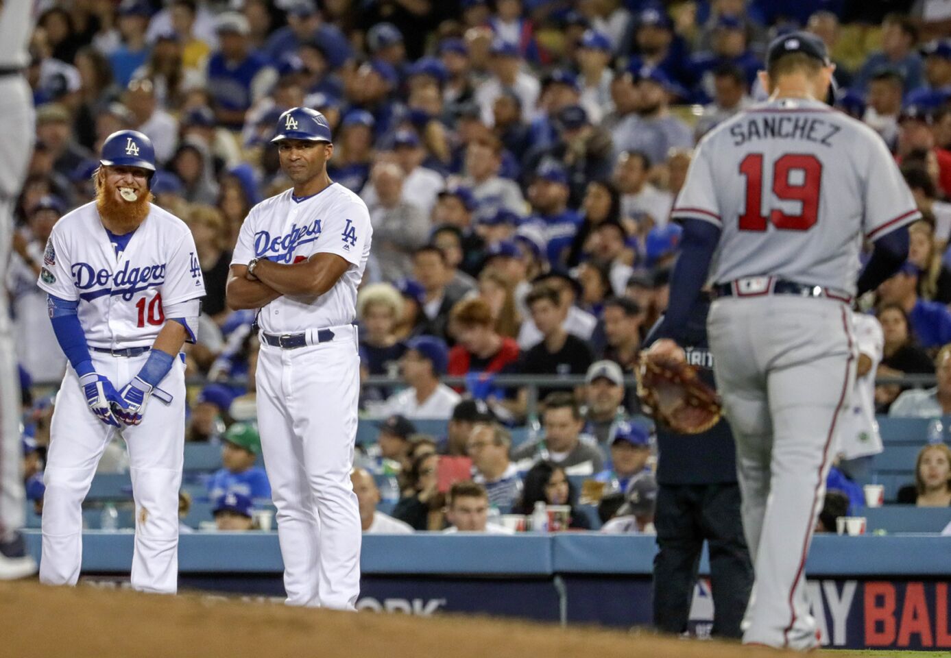 Dodgers third baseman Justin Turner flashes a coy smile at Braves pitcher Anibal Sanchez after achieving a bloop hit in the fifth inning, forcing Sanchez out of the game.