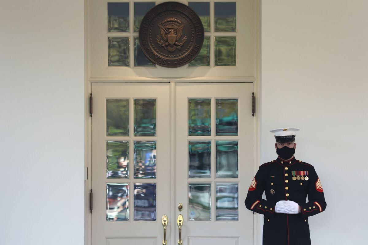  A U.S. Marine stands guard outside the West Wing at the White House 