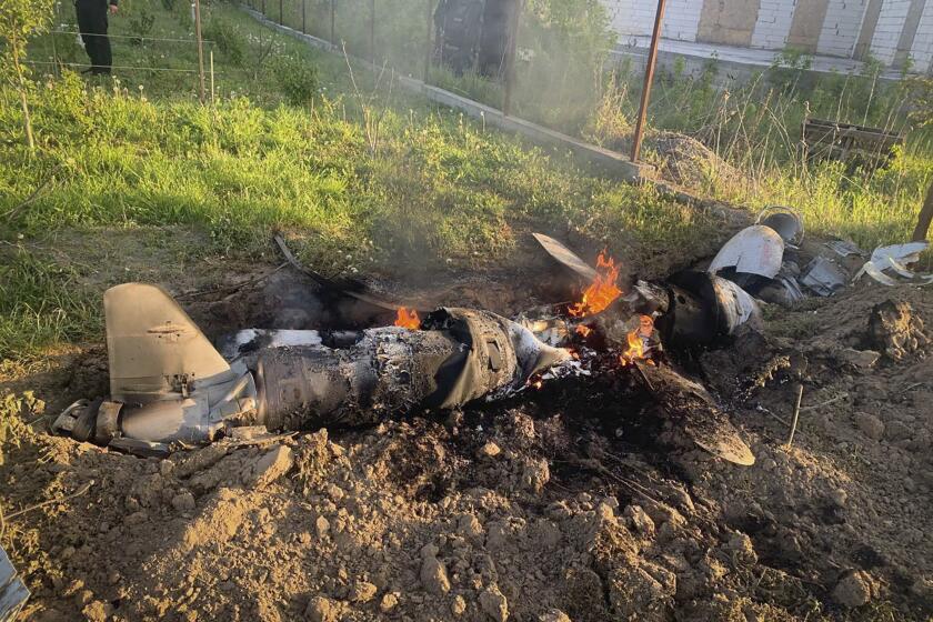 In this photo provided by the Ukrainian Police Press Office, fragments of a Russian rocket which was shot down by Ukraine's air defence system are seen after the night rocket attack in the Kyiv region, Ukraine, Thursday, May 18, 2023. (Ukrainian Police Press Office via AP)