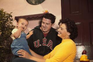 Olympic champions Harold Connolly and Olga Fikotova with their son. The pair met.