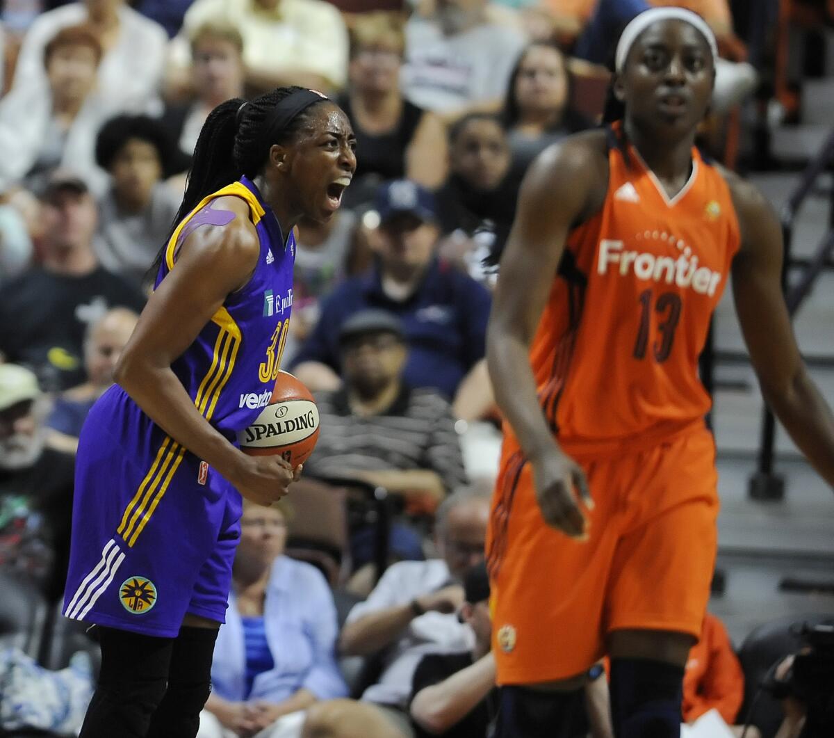 Sparks forward Nneka Ogwumike, left, reacts after forcing sister and Connecticut Sun forward Chiney Ogwumike, right, into a shot clock violation during the second half.