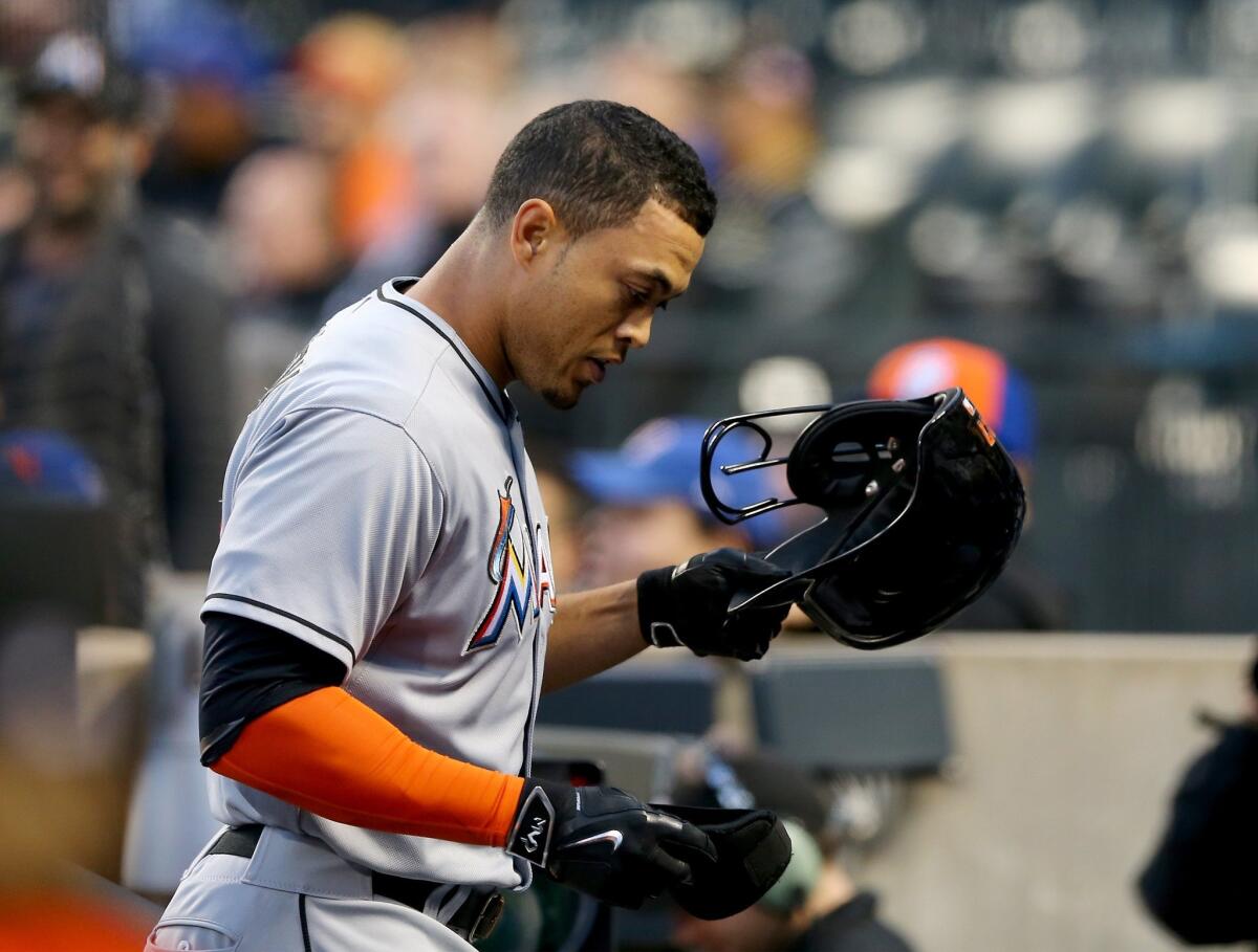 Marlins right fielder Giancarlo Stanton steps into the dugout after hitting a two-run home run in the first inning against the Mets on April 16 at Citi Field.