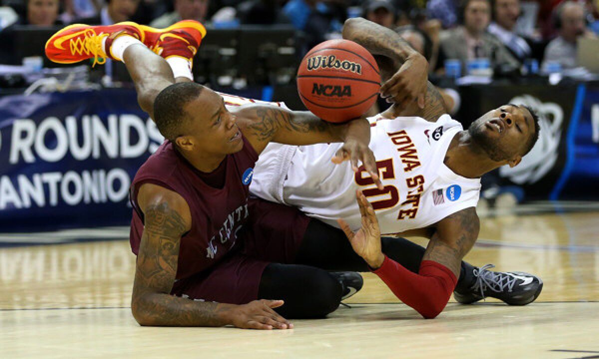 North Carolina Central's Alfonzo Houston, left, battles Iowa State's DeAndre Kane for a loose ball during the Cyclones' 93-75 win Friday in the second round of the NCAA tournament.