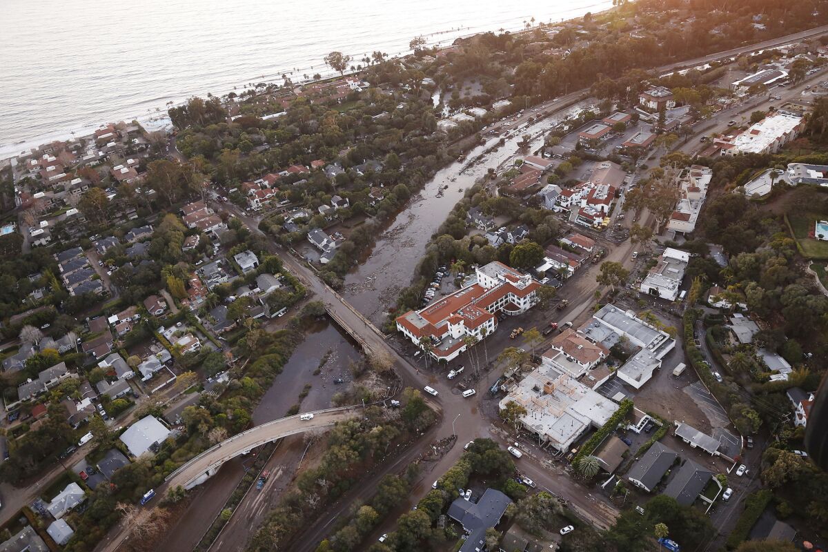 Mud, water and debris clog the 101 Freeway at the Olive Mill Road overpass in Montecito.