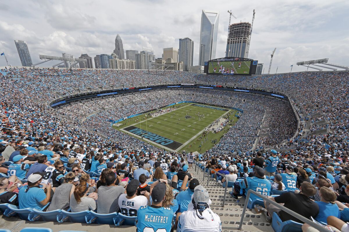 FILE - Fans watch the Cincinnati Bengals take on the Carolina Panthers during the second half of an NFL football game in Charlotte, N.C., Sunday, Sept. 23, 2018. The Carolina Panthers announced Thursday, March 10, 2022, season ticket prices for non-premium seats will remain the same for the 2022 season as they were last season. (AP Photo/Bob Leverone, File)