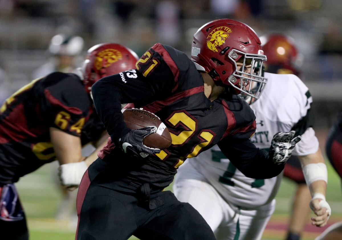 La Canada High School football player #21 Jacob Hardy gains yards in game vs. Temple City High School, at home in La Canada Flintridge on Friday, Oct. 4, 2019.