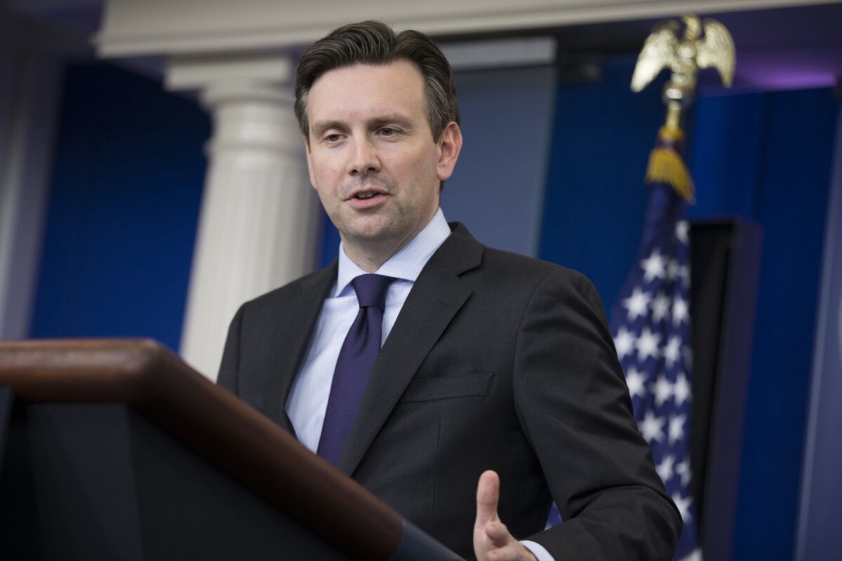 White House Press Secretary Josh Earnest answers a question about Republican presidential front-runner Donald Trump during Earnest's daily press briefing on Tuesday in Washington.