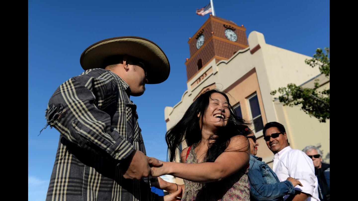 Miki and Gavin Takahe-Sanchez dance in the streets of Santa Paula, Calif., on June 12, 2016. The Ojai Music Festival, which took place over the course of three days, ended with a large party in Santa Paula.