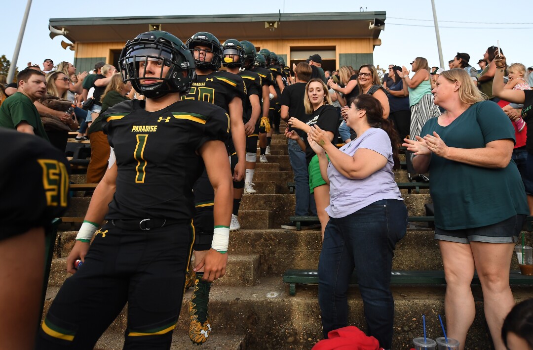 Spencer Kiefer leads the Paradise High School football team onto the field before their 2019 home opener.