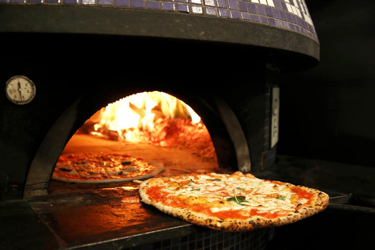 Pizzas are sent into the oven at L'Antica Pizzeria da Michele