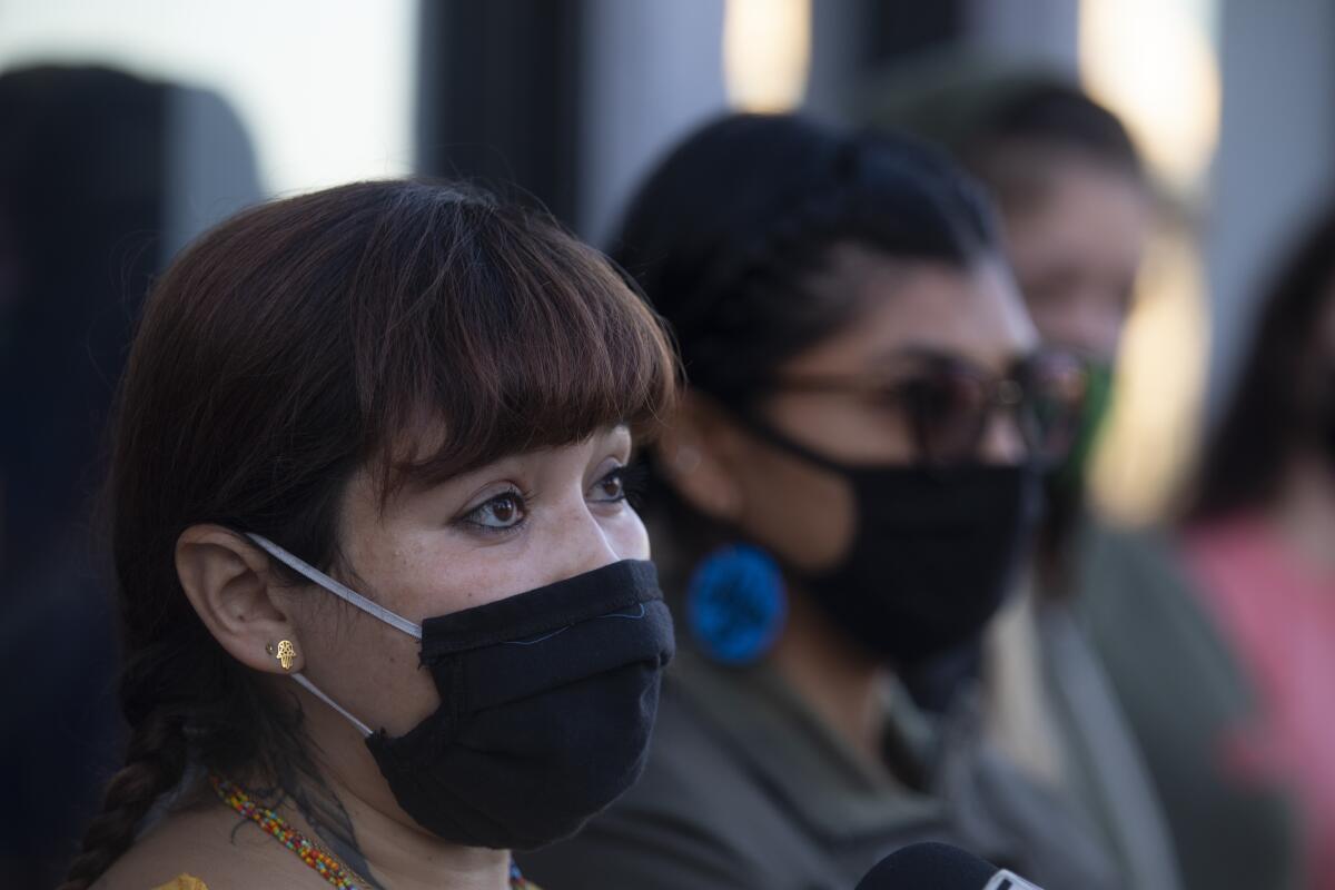 Iris De Anda, 41, a member of Reclaim and Rebuild Our Community, speaks during a press conference in the El Sereno. 
