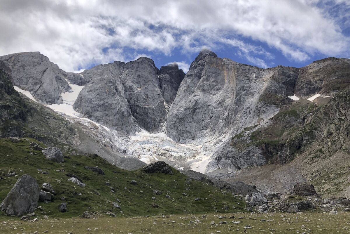 A view of the Petit Vignemale glacier, left, and the Oulettes, right, on the Vignemale massif's north face in the Pyrenean mountain range, as seen from the Gaube valley in southern France, Sunday, Aug. 3, 2020. Spanish scientists say Europe's southernmost glaciers will likely be reduced to ice patches in the next two decades due to climate change. The study also found that the shrinking of ice mass on the Pyrenees mountain range is continuing at the steady but rapid speed seen at least since the 1980s. (AP Photo/Aritz Parra)