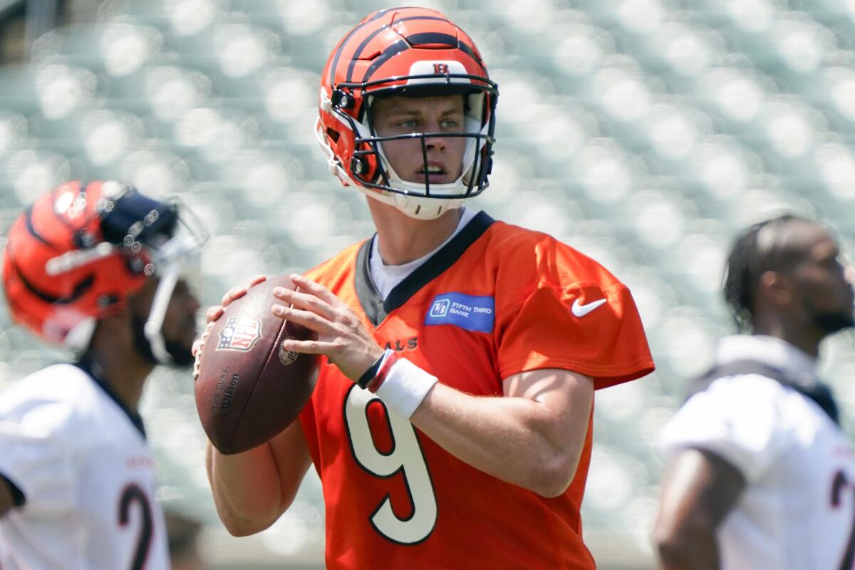 FILE - Cincinnati Bengals quarterback Joe Burrow (9) takes part in drills at the team's NFL football stadium, Tuesday, June 14, 2022, in Cincinnati. Bengals owner Mike Brown said the team already has an eye on structuring finances so they can pay Joe Burrow enough to stay in Cincinnati when the star quarterback becomes eligible to negotiate a new contract next year. (AP Photo/Jeff Dean, File)