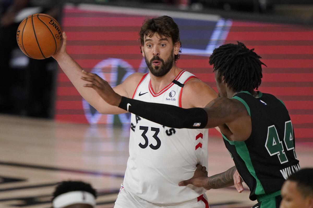 Toronto's Marc Gasol looks to pass around Boston's Robert Williams III.