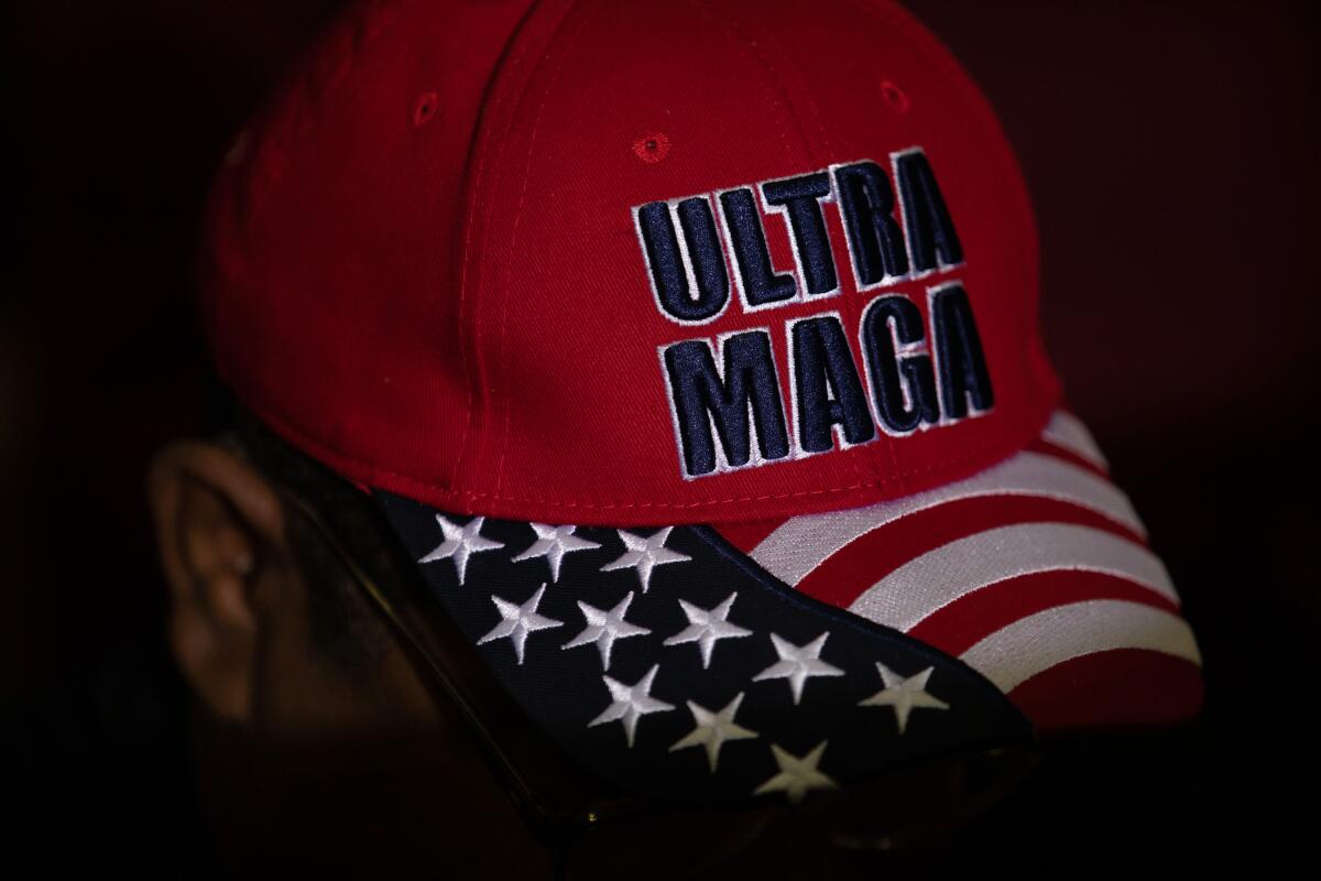 A Trump supporter's hat that reads "Ultra MAGA" with a flag motif on the bill 