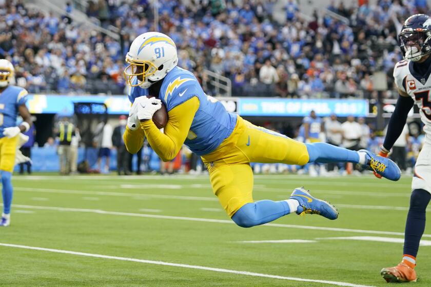 Los Angeles Chargers wide receiver Mike Williams (81) catches a touchdown in front of Denver Broncos.