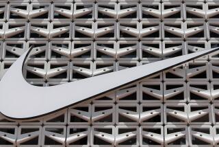 File - The Nike logo is shown on a store in Miami Beach, Fla. on Aug. 8, 2017. (AP Photo/Alan Diaz, File)