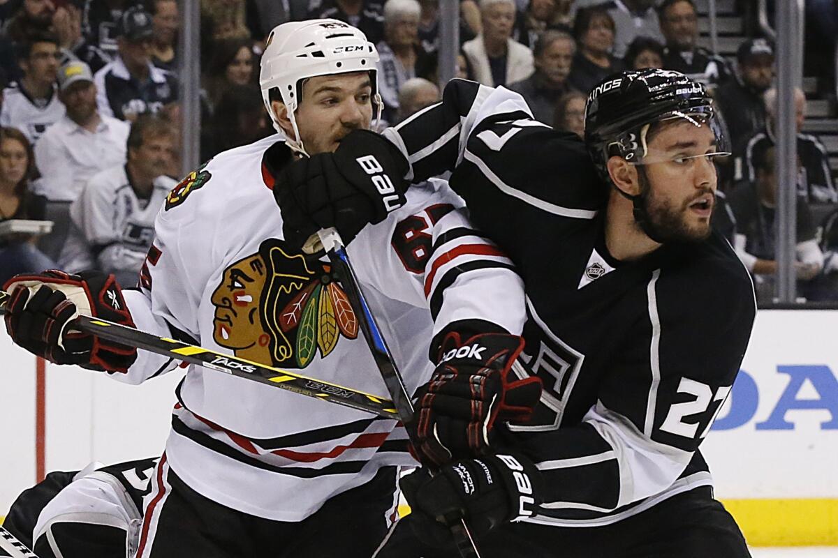 Chicago's Andrew Shaw, left, and Alec Martinez, right, battle for position during Game 4 of the Western Conference finals at Staples Center.